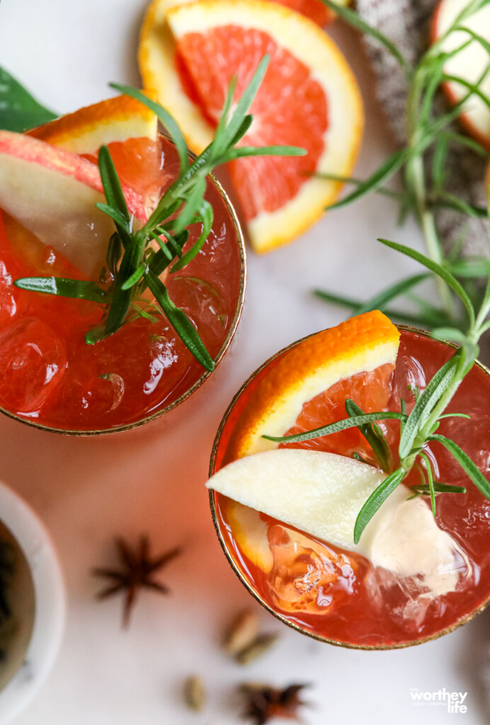 Two glasses of our Mulled Moscow Mule with rosemary