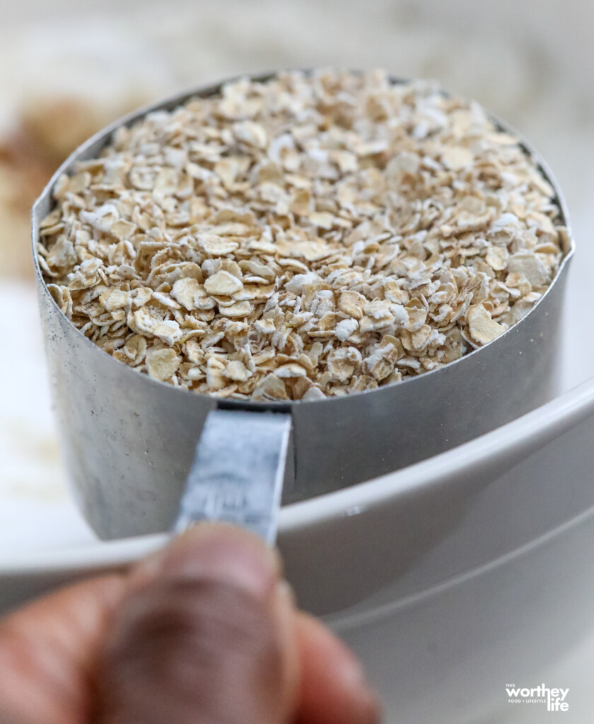 A measuring cup of rolled oats. 