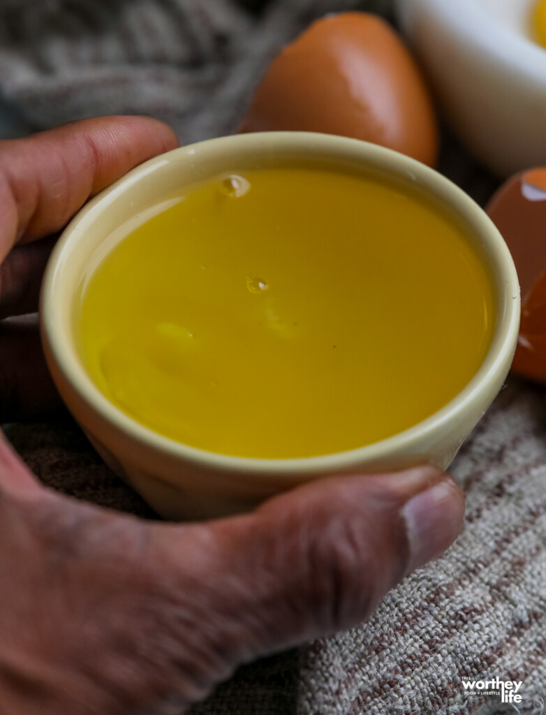 man holding melted butter in bowl