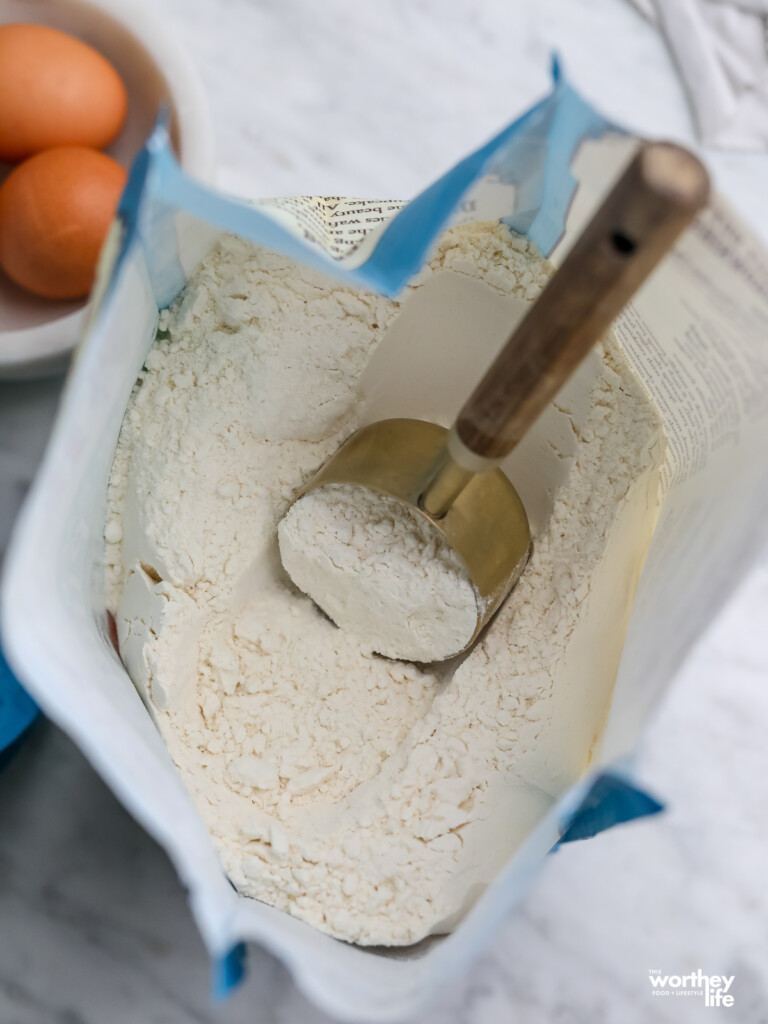 open bag of Bob's Red mill organic flour with eggs in background