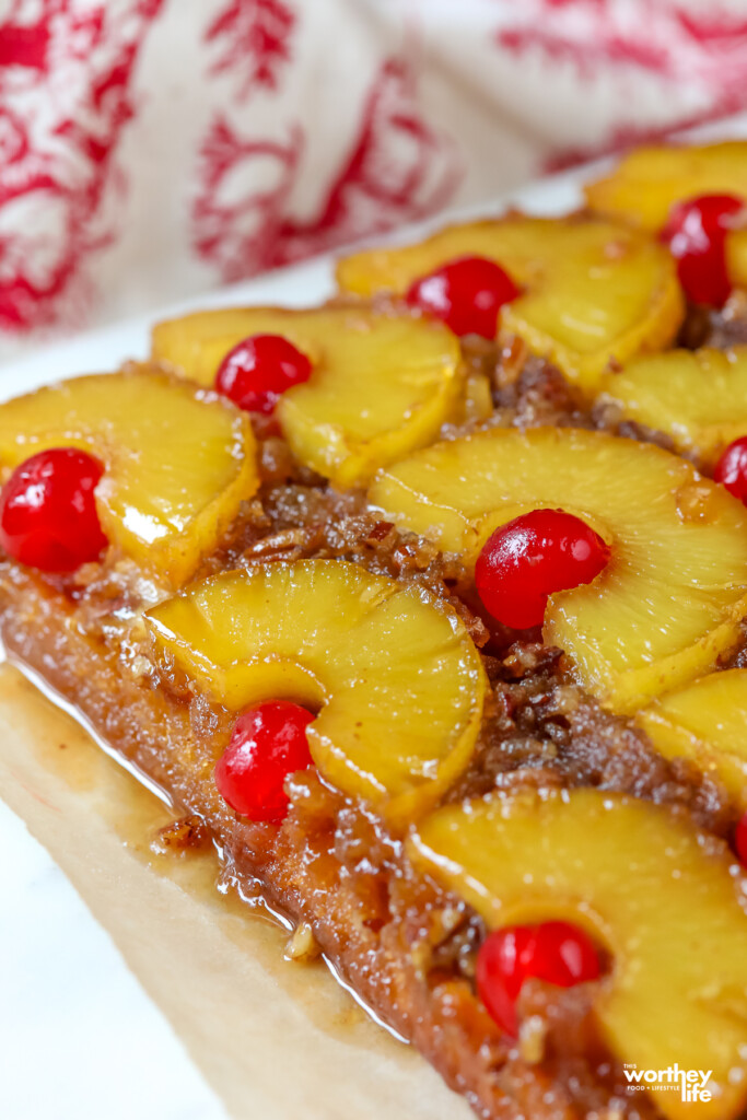 freshly baked pineapple upside down cake with bright red cherries