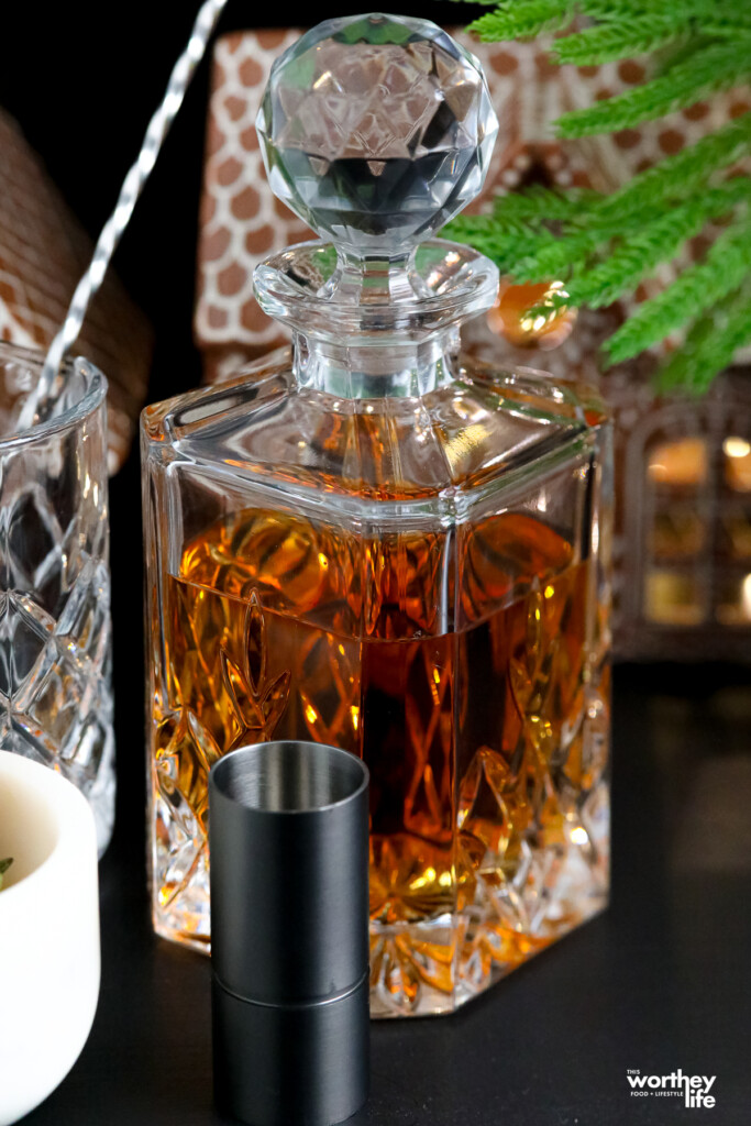 bourbon in a decanter and a black jigger