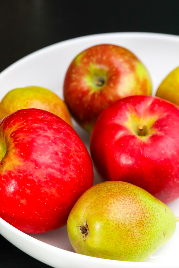 apples and pears in a white bowl