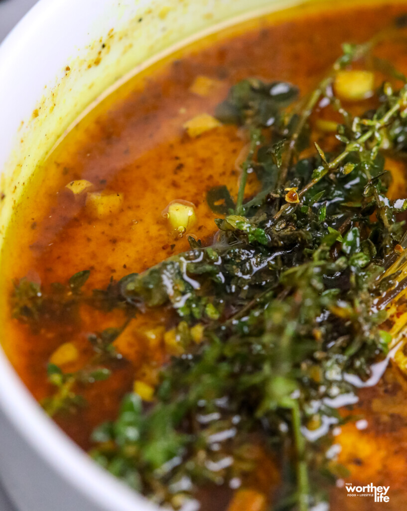 mixing herbs in a white bowl