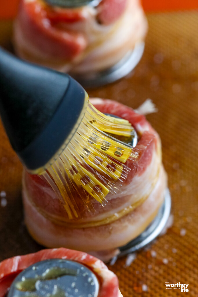 brushing oil onto a bacon ring