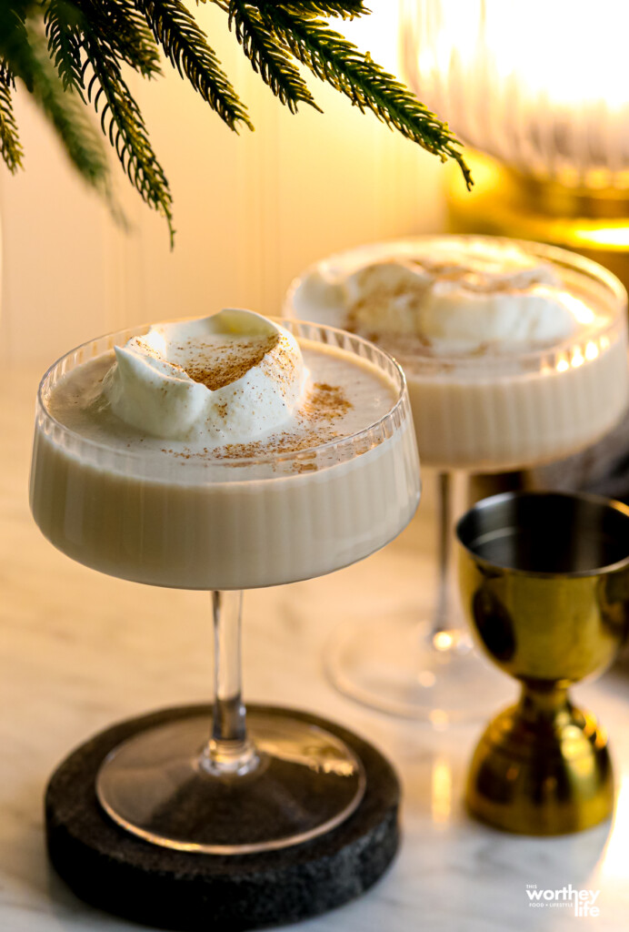 Two gingerbread martinis on white marble background