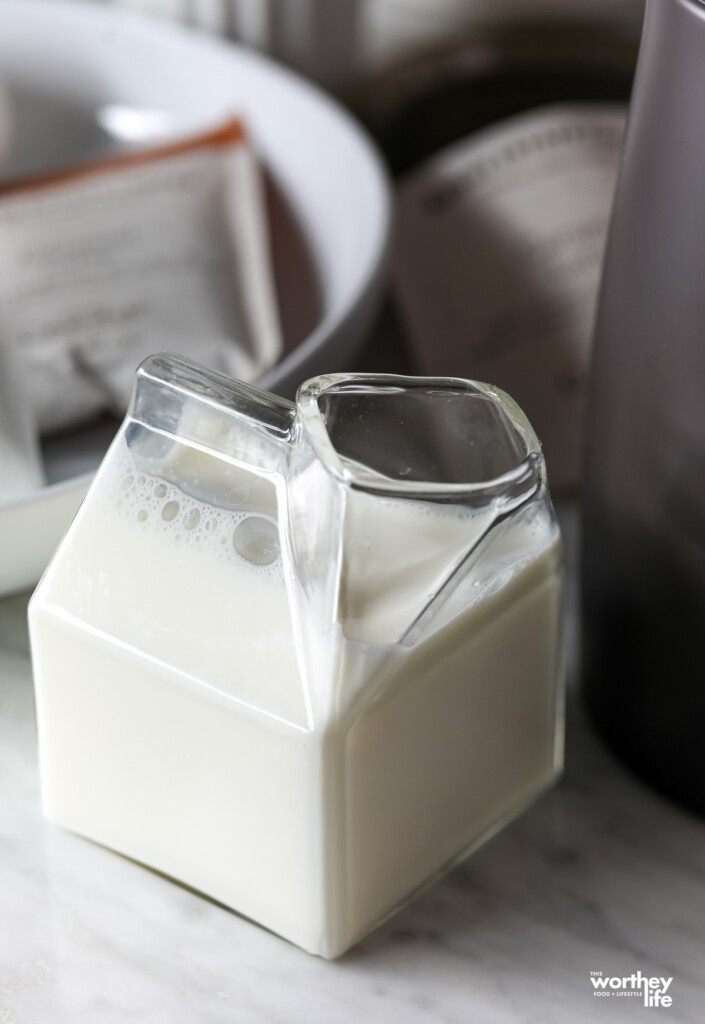  A glass carton of half and half milk.