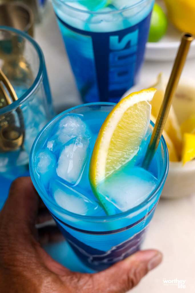 man holding a detroit lions cocktail in a detroit lions glass