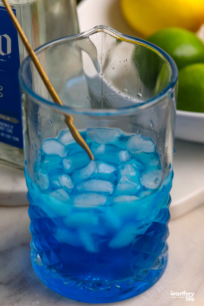 blue ingredients in a cocktail mixing glass