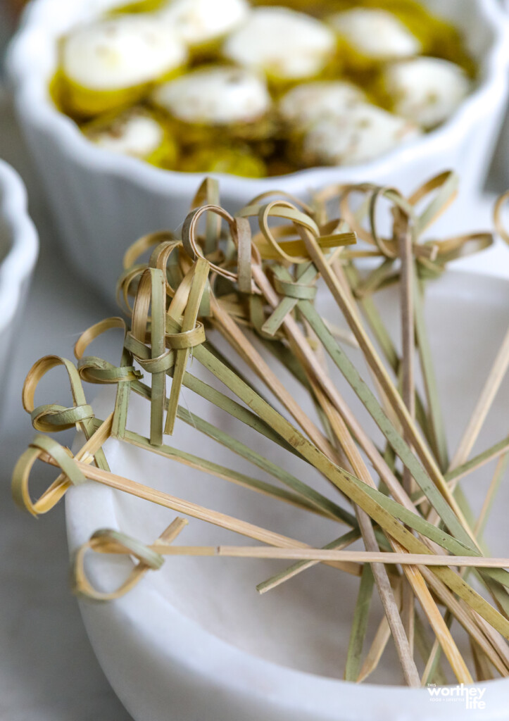 wooden bamboo skewers in white marble bowl