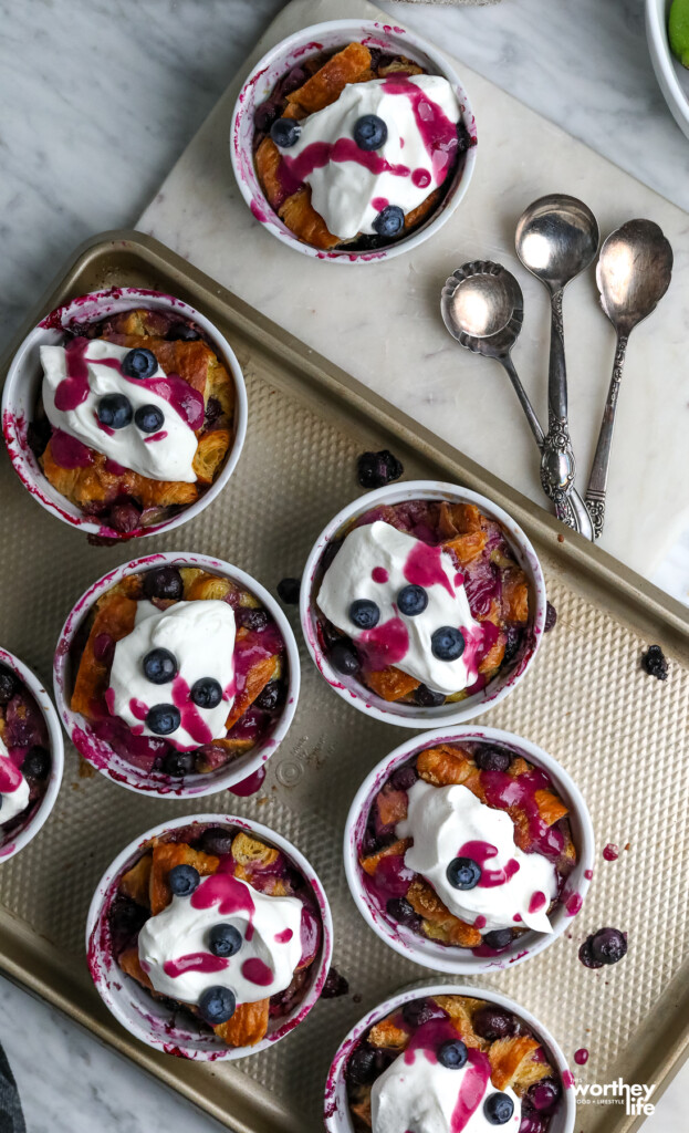 Blueberry Croissant Custard in white ramekins on baking sheet