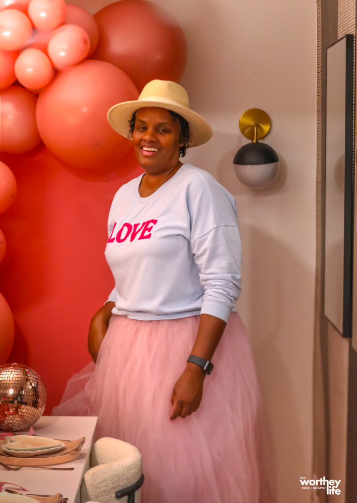 Woman wearing a love blue shirt with pink tutu skirt for galentine's
