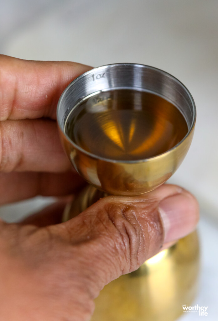 man holding gold jigger