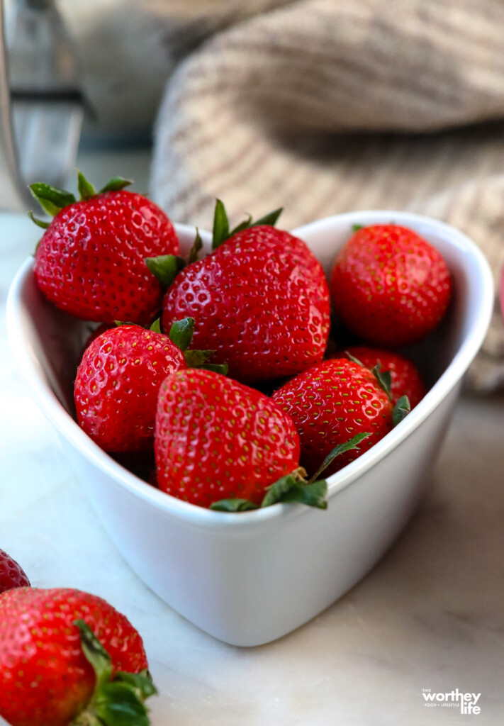 fresh strawberries in a heart shaped dish