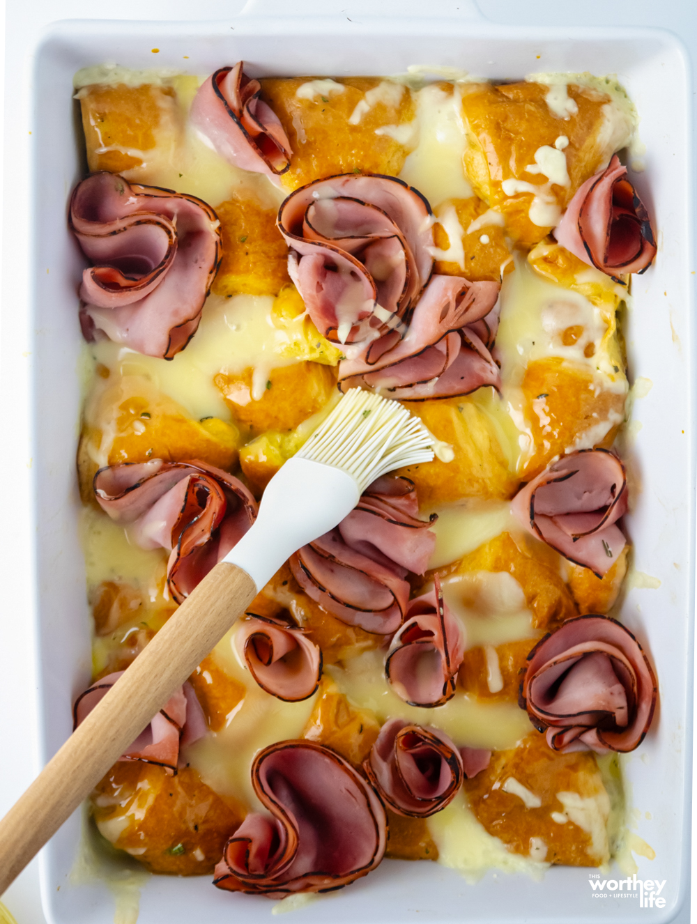 wooden food brush putting sauce on casserole