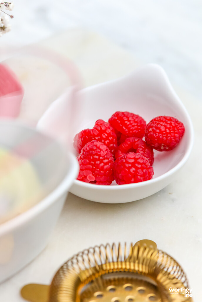 fresh raspberries in white bowl