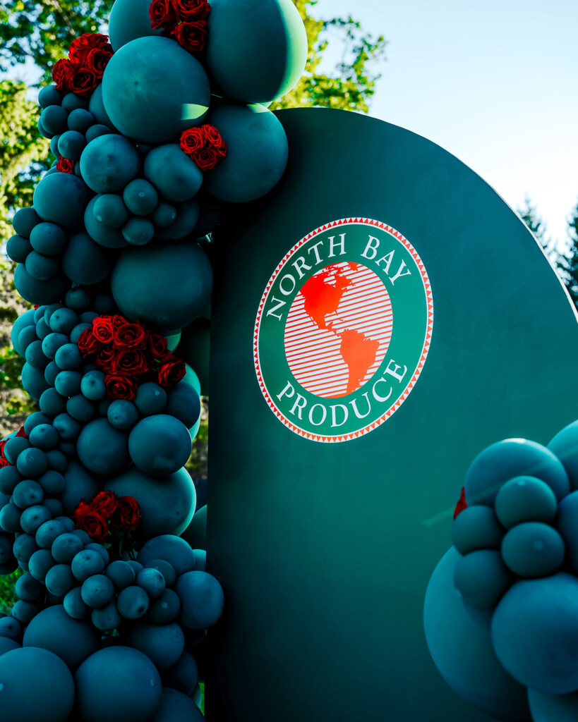 North Bay Produce logo with a balloon wall 