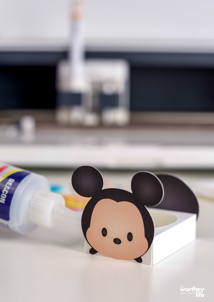 gluing together a Mickey Mouse Disney egg holder