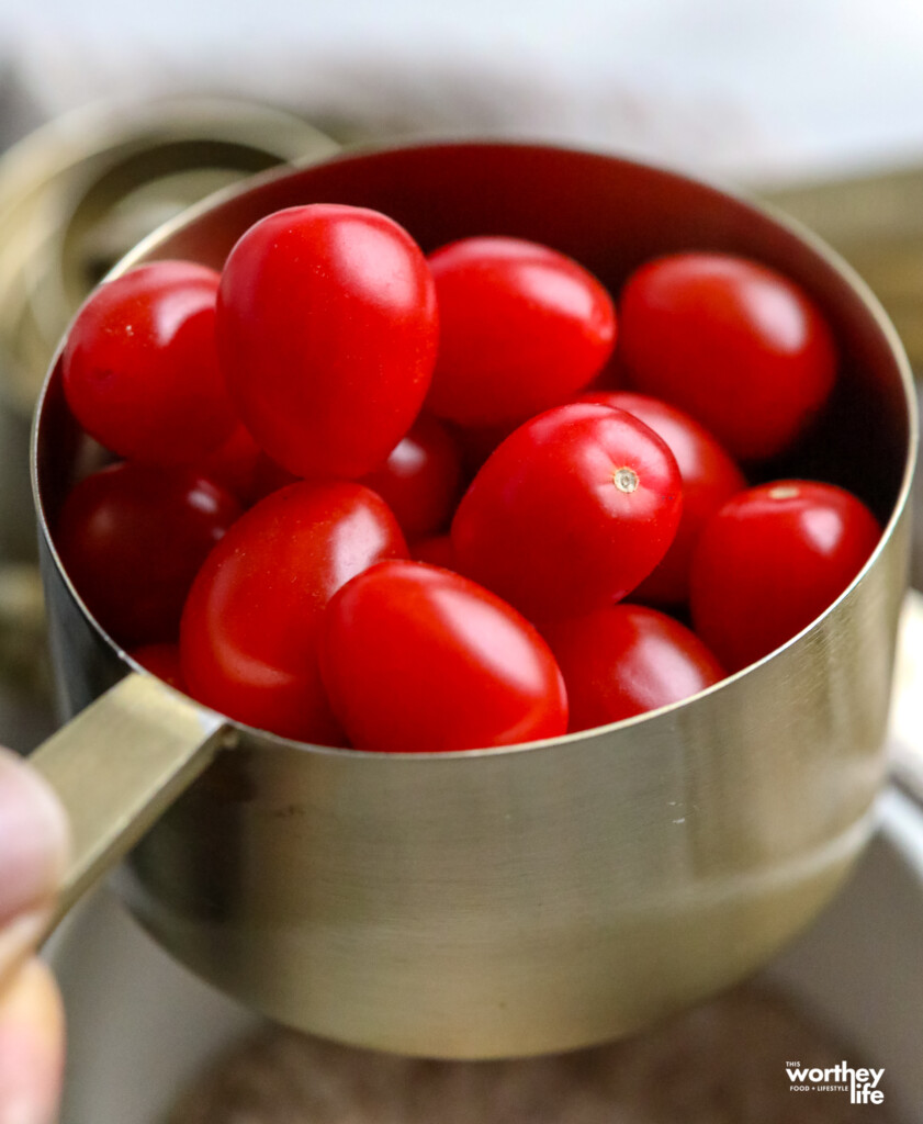 fresh tomatoes in a measuring cup