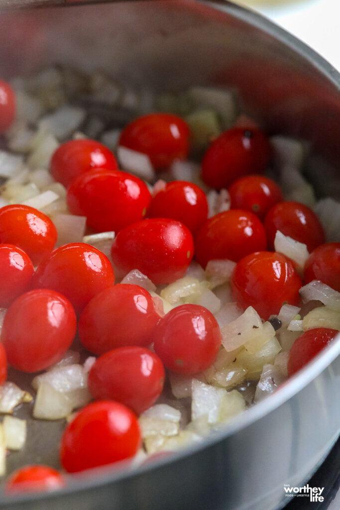 fresh tomatoes going into a pan to make a creamy sauce