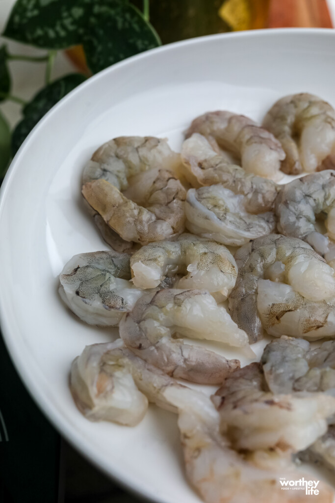 shrimp peeled with the tails off and deveined on white plate