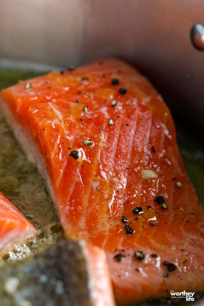 frying salmon in saucepan 