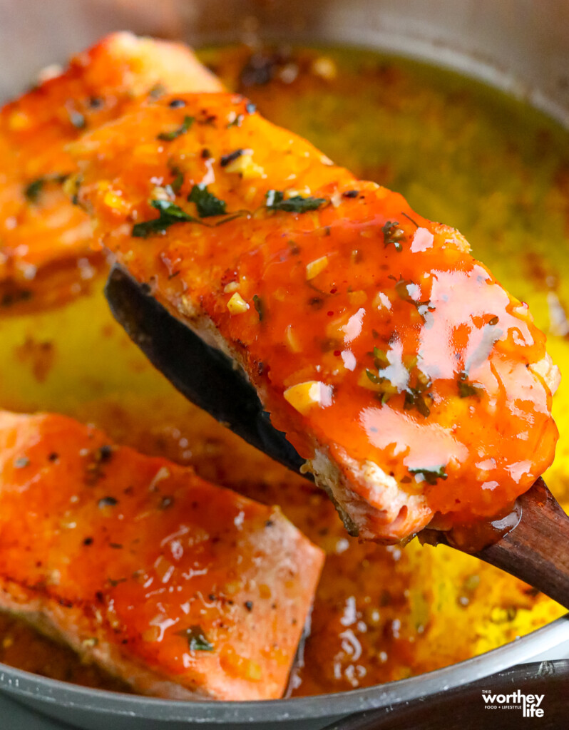 lifting pan fried salmon out of the pan with a spatula