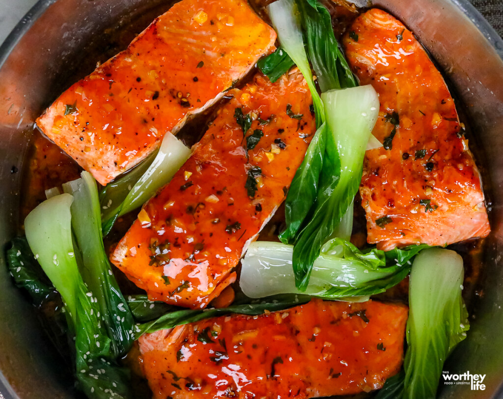 honey orange salmon with bok choy in pan