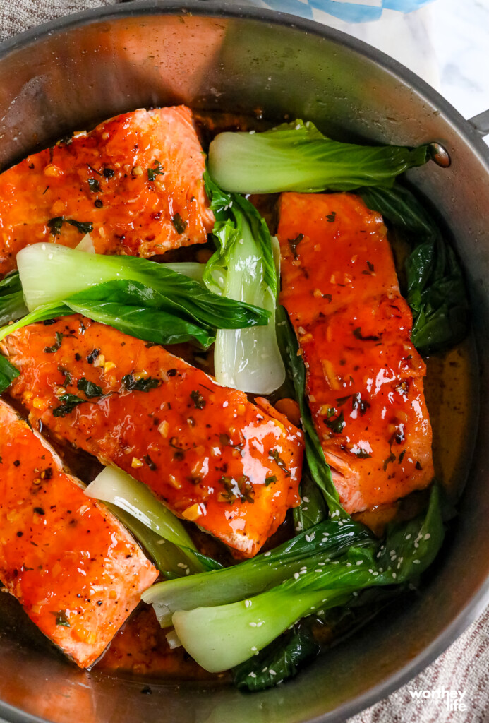 Hot Honey Orange Salmon in a pan with bok choy
