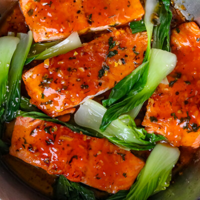 pan fried salmon in pan with bok choy