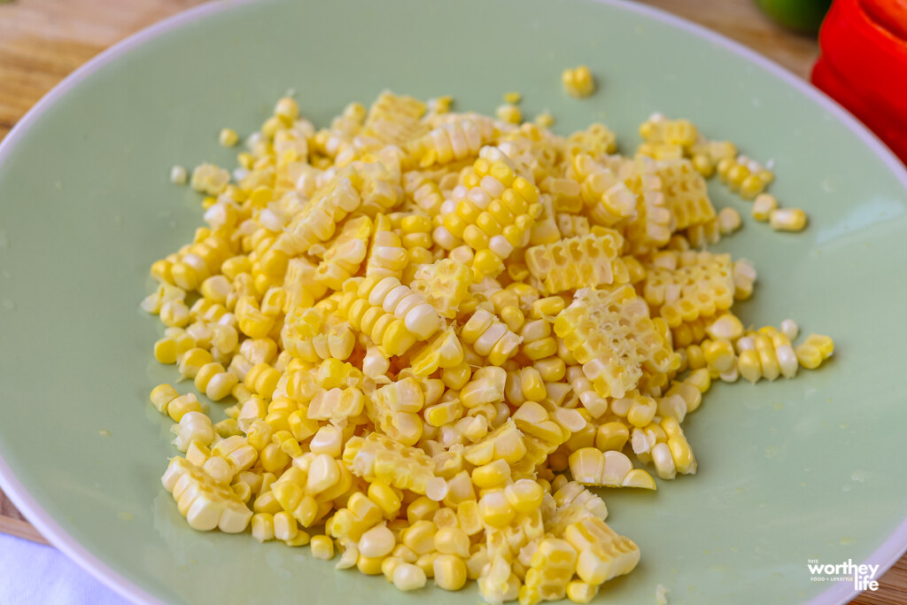 fresh corn on the cob on a green plate