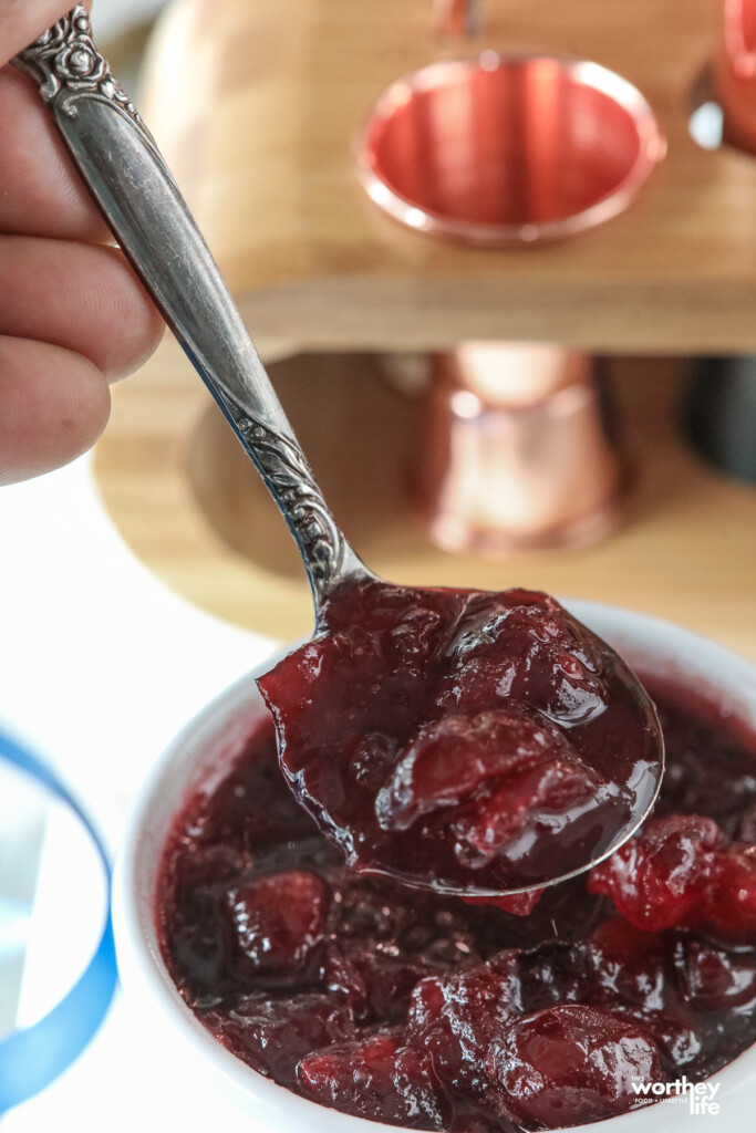 spooning cranberry sauce