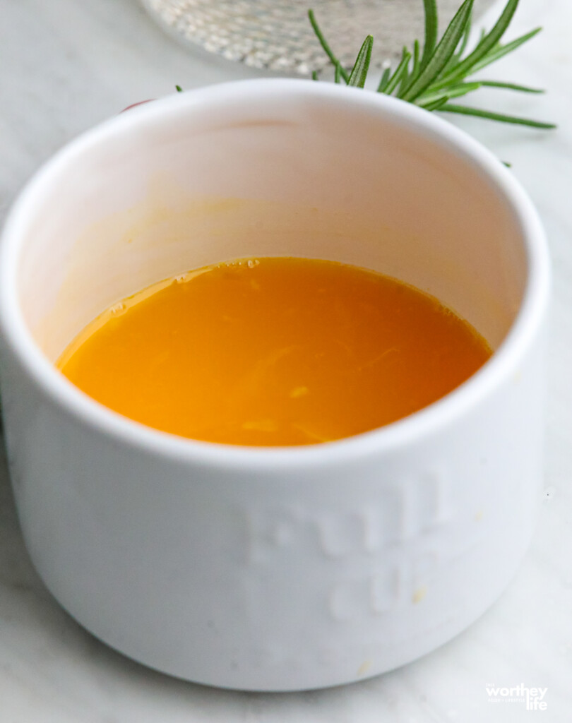 orange juice in a white cup