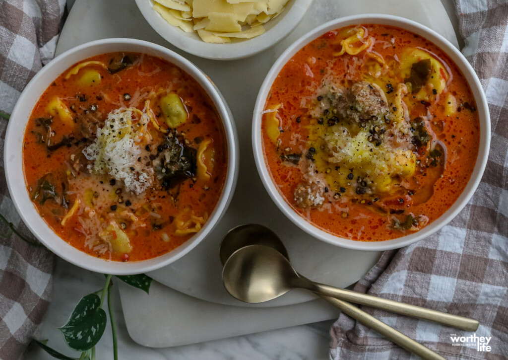 two bowls with heaping amounts of creamy tomato pasta soup