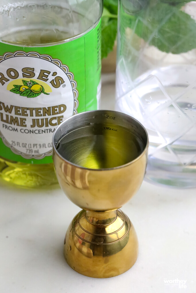 gold cocktail jigger on a marble background